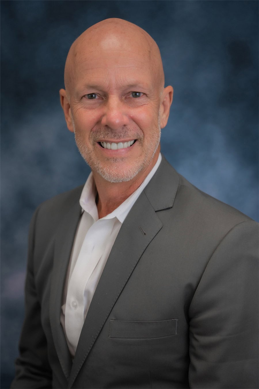 Charlie Dombek professional headshot — CPA, MBA, founder of Axium Wealth